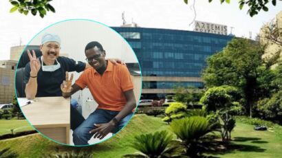 Dr. Biswajyoti Hazarika, Chief of Head and Neck Surgery at Artemis Hospital, and his patient Kizito Namulanda, who has recovered from a partial laryngectomy, pose together outside Artemis Hospital; in-set shows them smiling inside a clinic room.